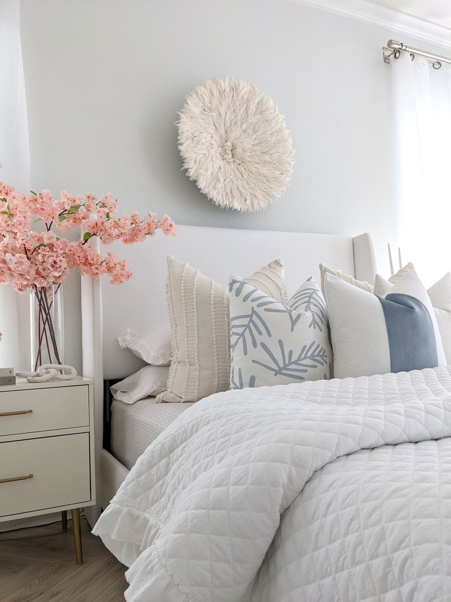 white bedding with accent pillows
